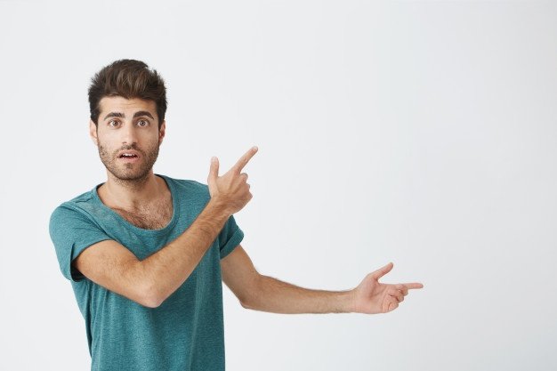Indoor Shot Astonished Good Looking Man Dressed Casual Cloth Having Excited Fascinated Look Indicating Blank Wall With His Index Finger Isolated Shot Horizontal 176420 10313